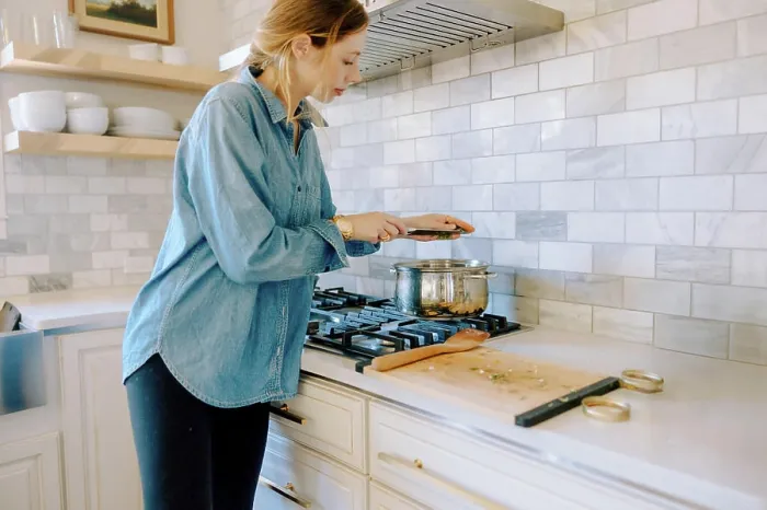 Framed Print : Woman adding spices to butternut squash soup on stove Framed Print : Woman adding spices to butternut squash soup on stove