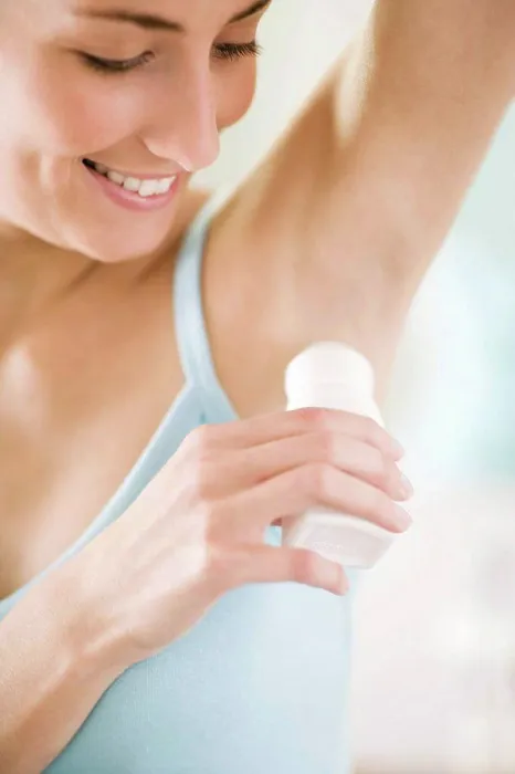 Framed Print : Woman applying deodorant Framed Print : Woman applying deodorant