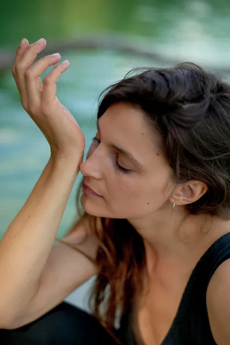 Framed Print : Woman in a black tank top enjoying a peaceful moment by the water with her eyes closed