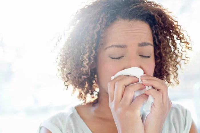 Framed Print : Woman blowing nose on tissue Framed Print : Woman blowing nose on tissue