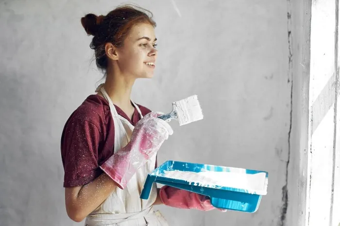 Framed Print : woman with brush in hands paint inside home interior renovation