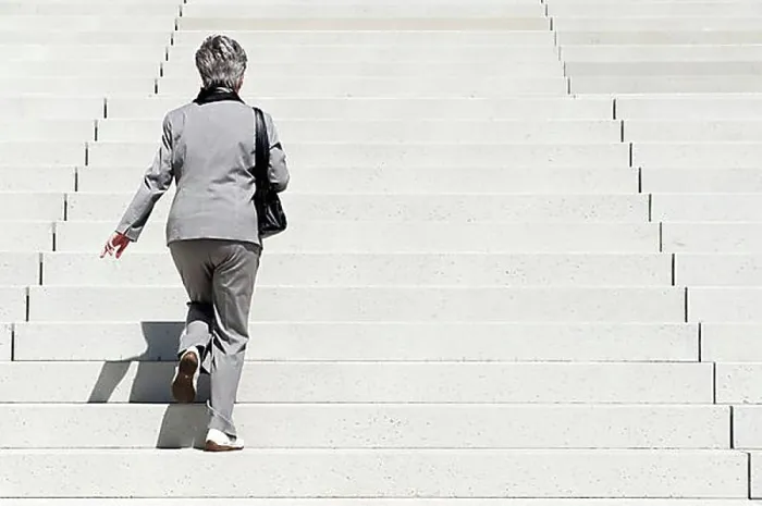 Framed Print : Woman climbing up stairs Framed Print : Woman climbing up stairs