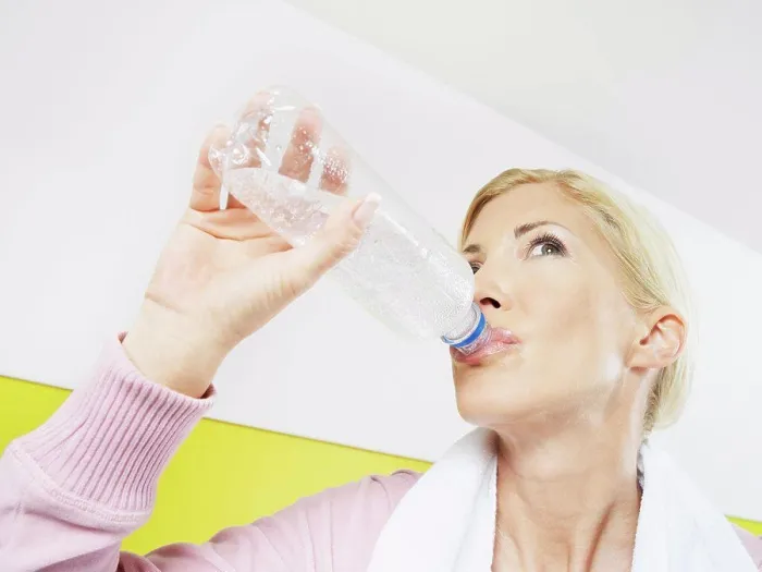Framed Print : Woman drinking water in health club Framed Print : Woman drinking water in health club