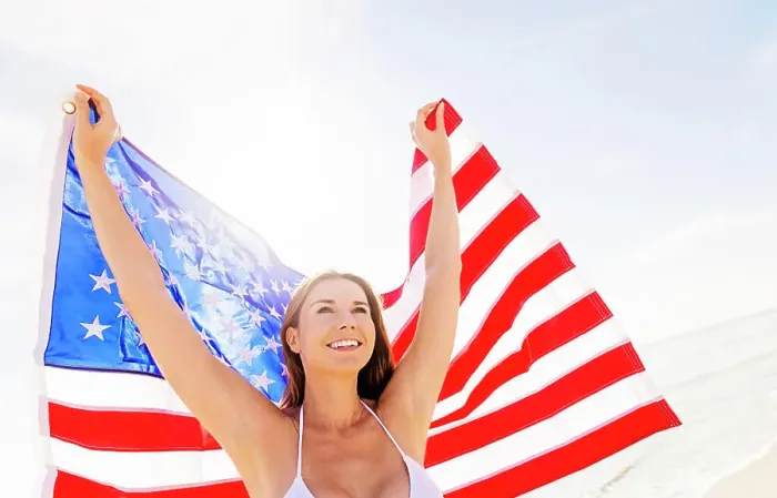 Framed Print : Woman holding American flag