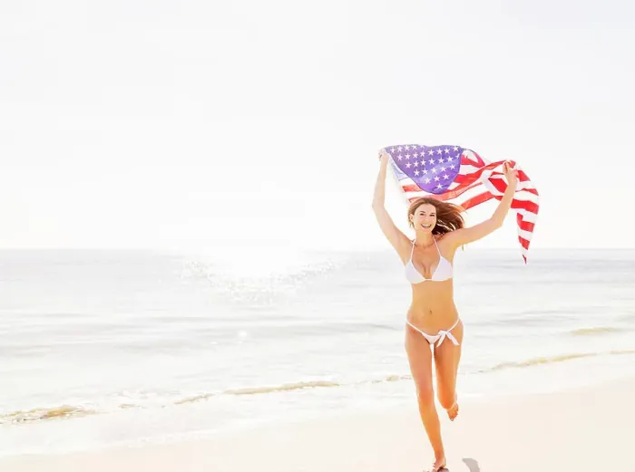 Framed Print : Woman holding American flag Framed Print : Woman holding American flag