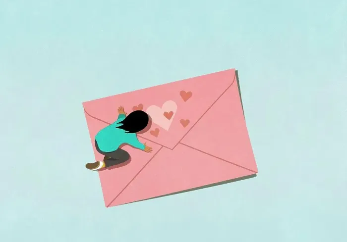 Framed Print : Woman kneeling over pink envelope with hearts