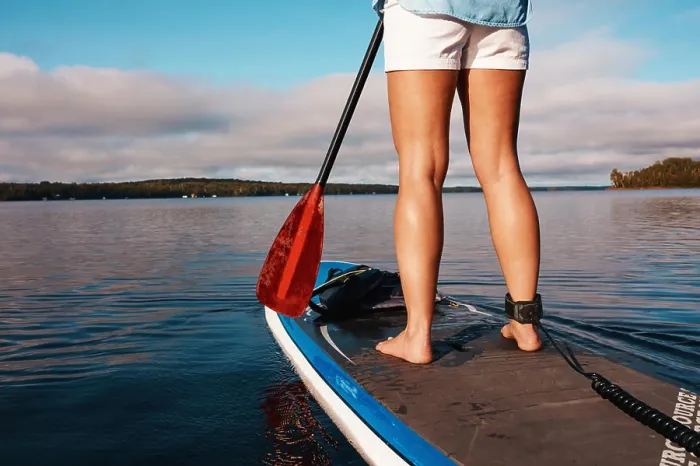 Framed Print : Woman, legs and paddle board in lake water for calm exercise with vacation Framed Print : Woman, legs and paddle board in lake water for calm exercise with vacation