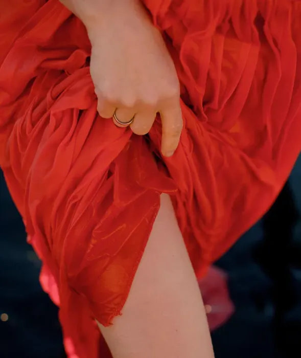 Framed Print : a woman lifts her red wet dress and exposes her legs Framed Print : a woman lifts her red wet dress and exposes her legs