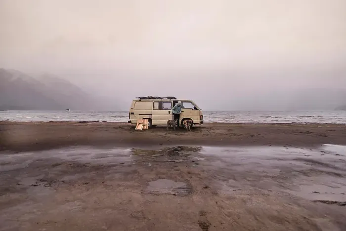 Framed Print : Woman and pet dogs by camper van on beach, Chile Framed Print : Woman and pet dogs by camper van on beach, Chile