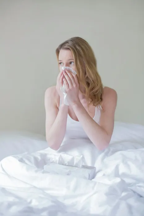 Framed Print : Woman sick with handkerschiefs in bed