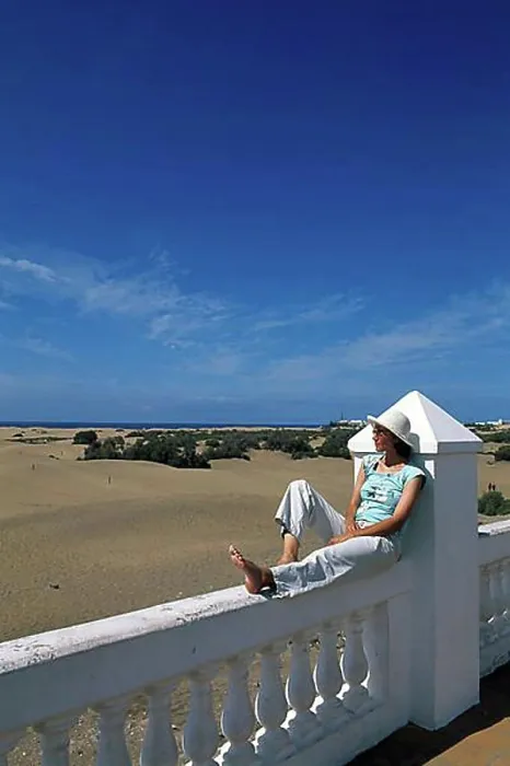 Framed Print : Woman sitting on a balustrade, railing of the RIU Palace Hotel Framed Print : Woman sitting on a balustrade, railing of the RIU Palace Hotel