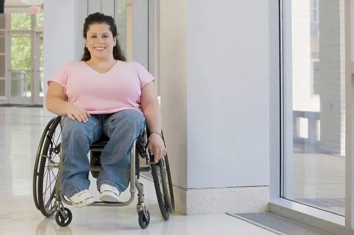 Framed Print : Woman with Spina Bifida sitting in a wheelchair and smiling Framed Print : Woman with Spina Bifida sitting in a wheelchair and smiling