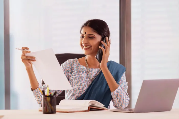 Framed Print : Woman talking on mobile phone in office Framed Print : Woman talking on mobile phone in office