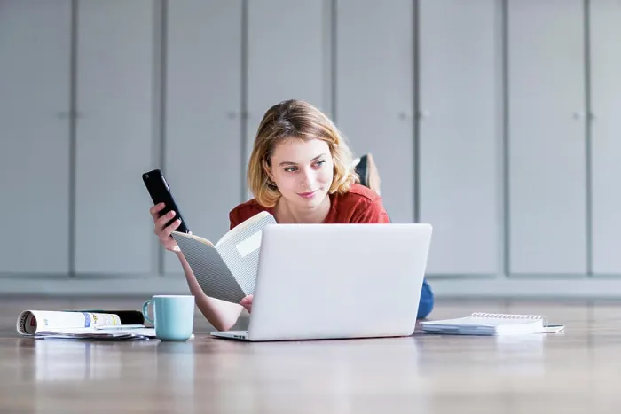 Framed Print : Woman using a laptop and a smartphone