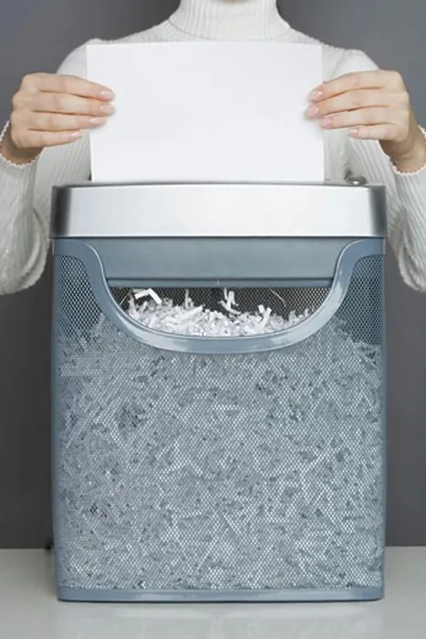 Framed Print : Woman using a paper shredder