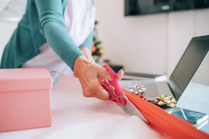 Framed Print : Woman wrapping Christmas gifts Framed Print : Woman wrapping Christmas gifts