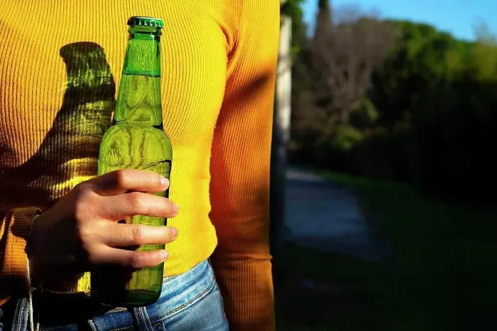 Framed Print : Woman with yellow shirt catching a green bottle of beer Framed Print : Woman with yellow shirt catching a green bottle of beer
