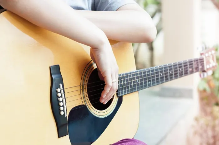 Framed Print : Woman's hands with acoustic guitar in relax post Framed Print : Woman's hands with acoustic guitar in relax post