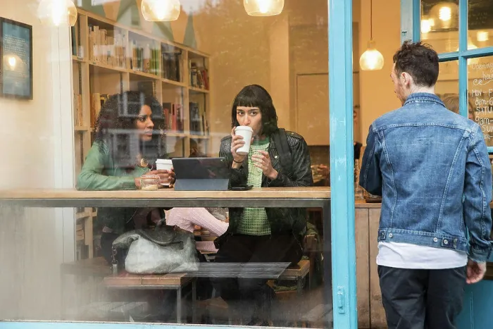 Framed Print : Two women sitting in window of cafe looking at tablet Framed Print : Two women sitting in window of cafe looking at tablet
