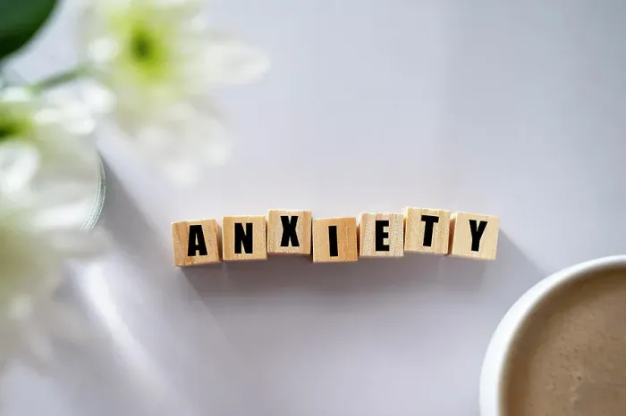 Framed Print : Wooden block with word ANXIETY. Mental health concept Framed Print : Wooden block with word ANXIETY. Mental health concept