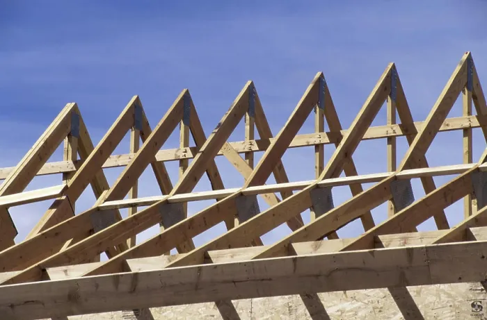 Framed Print : Wooden framework of a roof of a house under construction Framed Print : Wooden framework of a roof of a house under construction