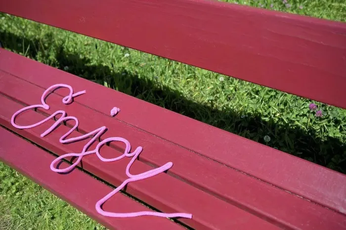 Framed Print : Word enjoy on a bench