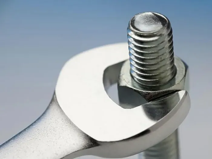 Framed Print : Wrench turning nut on bolt Framed Print : Wrench turning nut on bolt