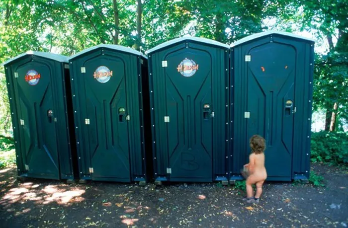 Framed Print : Yound child waiting naked outside line of outhouses or portable toilets at Stockholm city beach park in summer Framed Print : Yound child waiting naked outside line of outhouses or portable toilets at Stockholm city beach park in summer