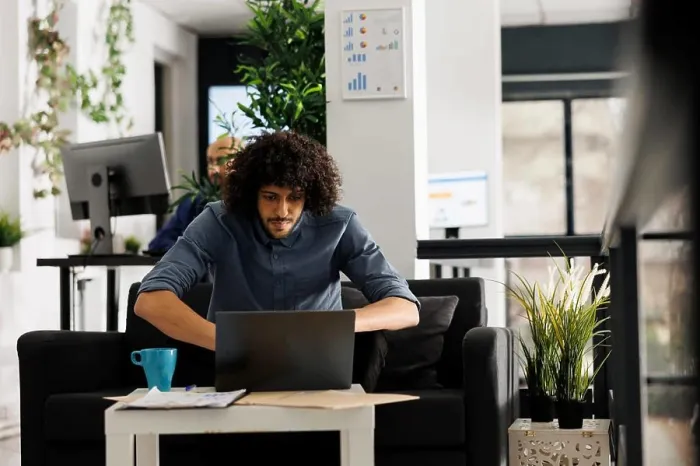 Framed Print : Young arab entrepreneur analyzing company sales statistics on laptop Framed Print : Young arab entrepreneur analyzing company sales statistics on laptop