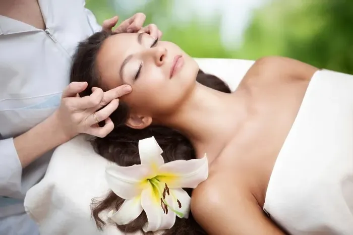 Framed Print : Young beautiful relaxing woman having a facial massage