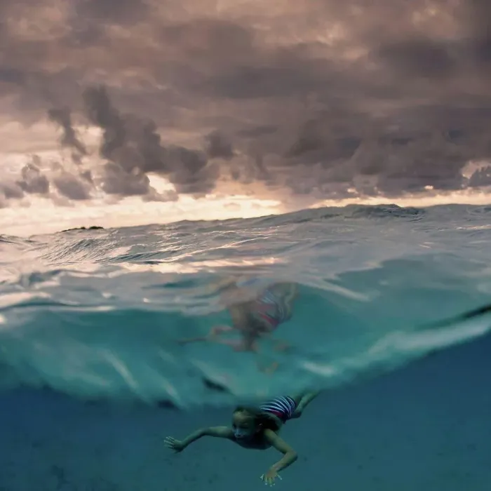 Framed Print : Young boy swimming underwater, split view, Tonga