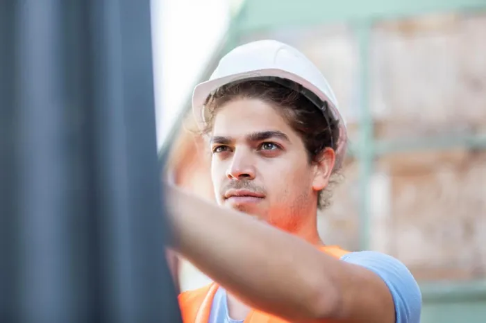 Framed Print : young construction engineer with helmet working outside