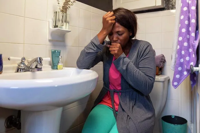Framed Print : Young coughing woman in the bathroom feeling ill Framed Print : Young coughing woman in the bathroom feeling ill