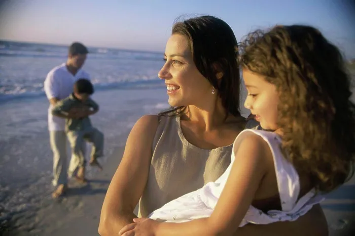 Framed Print : Young couple on the beach with their son and daughter Framed Print : Young couple on the beach with their son and daughter