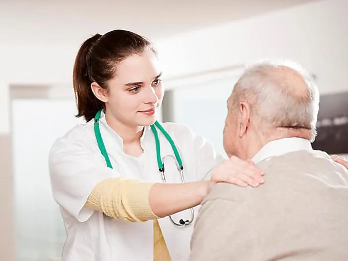 Framed Print : Young doctor taking care of an elderly man Framed Print : Young doctor taking care of an elderly man