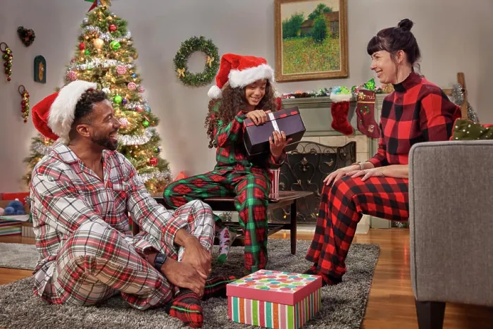 Framed Print : Young family and their daughter opening gifts and celebrating Christmas while in their Pajamas Framed Print : Young family and their daughter opening gifts and celebrating Christmas while in their Pajamas