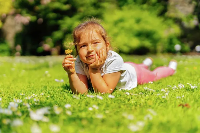 Framed Print : Young girl holding yellow Buttercup flower on meadow Young Caucasian white girl holding yellow Buttercup flower Framed Print : Young girl holding yellow Buttercup flower on meadow Young Caucasian white girl holding yellow Buttercup flower