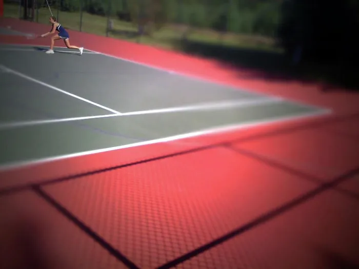 Framed Print : A young girl plays tennis on a bright day Framed Print : A young girl plays tennis on a bright day