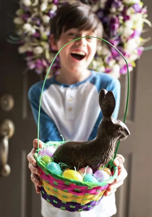 Framed Print : Young happy boy holding Easter basket full of eggs and chocolate bunny Framed Print : Young happy boy holding Easter basket full of eggs and chocolate bunny