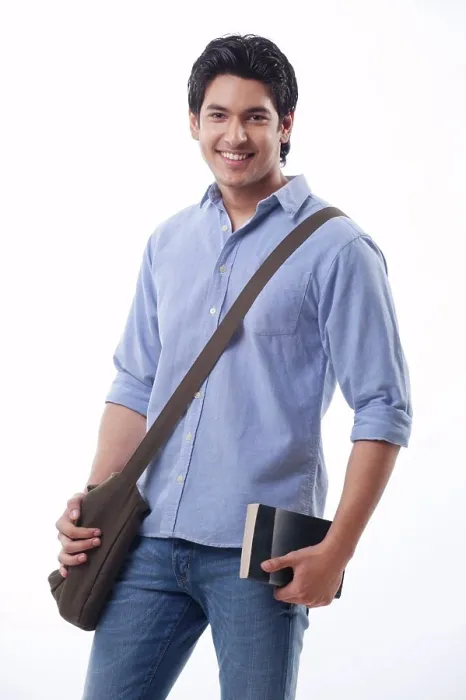 Framed Print : Young man holding book and shoulder bag Framed Print : Young man holding book and shoulder bag