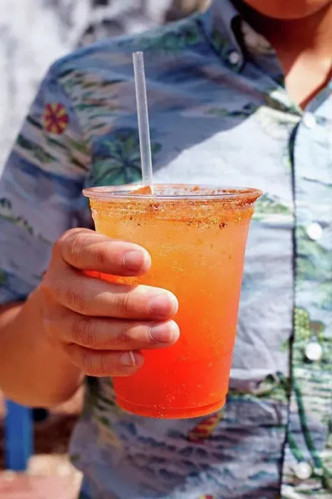 Framed Print : Young man holding michelada cocktail, mid section, close-up Framed Print : Young man holding michelada cocktail, mid section, close-up