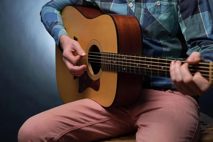 Framed Print : Young man playing on acoustic guitar close up Young man playing on acoustic guitar close up on dark blue background Framed Print : Young man playing on acoustic guitar close up Young man playing on acoustic guitar close up on dark blue background