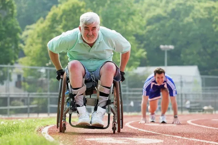 Framed Print : Young man racing with a senior man with Muscular Dystrophy on a racetrack Framed Print : Young man racing with a senior man with Muscular Dystrophy on a racetrack