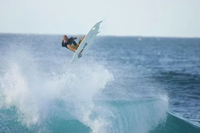Framed Print : A young man surfing at Rocky Point, north shore