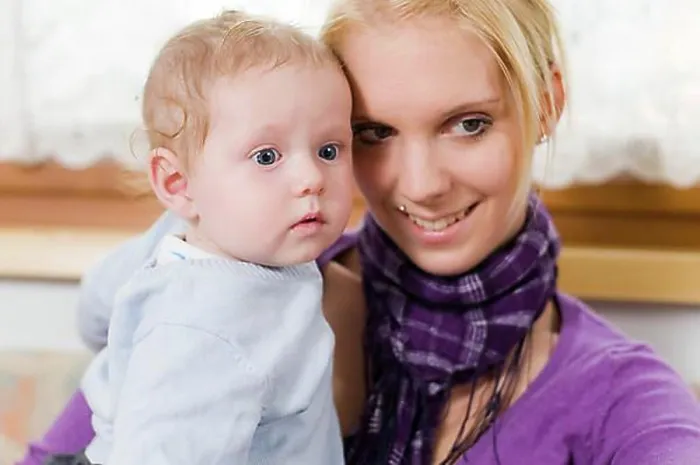 Framed Print : Young mother having fun with her toddler in her arms Framed Print : Young mother having fun with her toddler in her arms