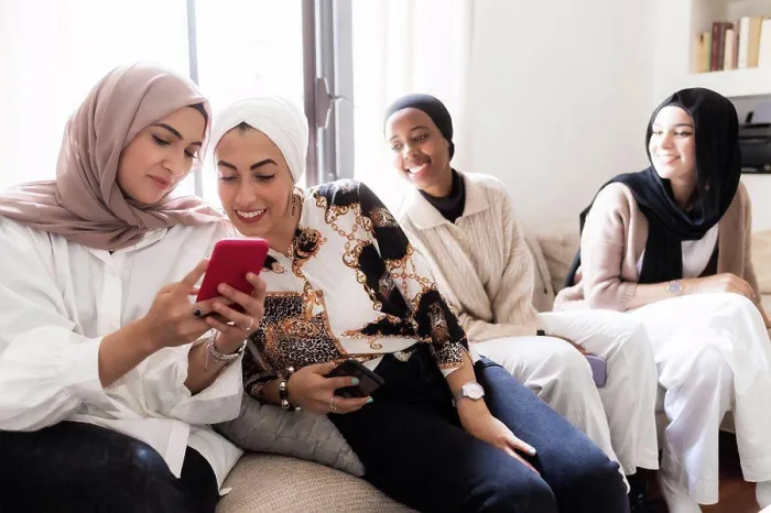 Framed Print : Four young muslim women, looking at cellphone Framed Print : Four young muslim women, looking at cellphone