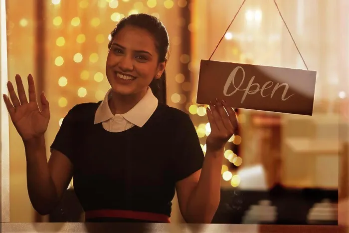 Framed Print : A YOUNG WAITRESS HAPPILY LOOKING AT CAMERA WHILE HOLDING OPEN SIGN BOARD Framed Print : A YOUNG WAITRESS HAPPILY LOOKING AT CAMERA WHILE HOLDING OPEN SIGN BOARD