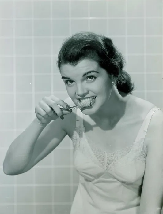 Framed Print : Young woman brushing teeth Framed Print : Young woman brushing teeth