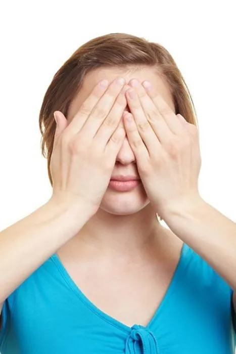 Framed Print : Young woman covering her eyes with both hands