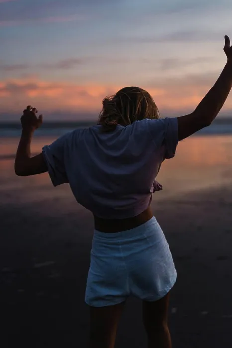 Framed Print : Young woman dancing at sunset on a tropical beach in Bali Framed Print : Young woman dancing at sunset on a tropical beach in Bali